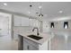 Bright, open kitchen with white cabinets, stainless appliances, kitchen island and sleek design at 10249 Spring Lake Dr, Clermont, FL 34711