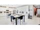 Bright kitchen with white cabinetry, stainless steel appliances, and a table with chairs, perfect for dining at 10249 Spring Lake Dr, Clermont, FL 34711