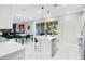 A well-lit kitchen featuring an island with seating and a view of the adjacent dining and living areas at 10249 Spring Lake Dr, Clermont, FL 34711