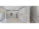 Open-concept kitchen with stainless steel appliances and a large island, seamlessly connected to staircase at 10249 Spring Lake Dr, Clermont, FL 34711