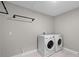 Functional laundry room equipped with a washer and dryer, and featuring modern utility connections at 10249 Spring Lake Dr, Clermont, FL 34711