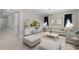 Living room features stylish seating, a modern entertainment center and overhead chandelier lighting at 10249 Spring Lake Dr, Clermont, FL 34711