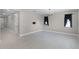 Spacious room with chandelier lighting, neutral tile floor, and blank walls at 10249 Spring Lake Dr, Clermont, FL 34711