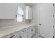Well-organized mud room with cabinetry, countertop space, and a window for natural light at 10249 Spring Lake Dr, Clermont, FL 34711