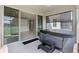 This covered patio boasts a relaxing hot tub and seamless indoor-outdoor flow into the home's kitchen at 10249 Spring Lake Dr, Clermont, FL 34711