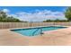 Community pool featuring crystal-clear water, surrounded by a white picket fence on a sunny day at 10249 Spring Lake Dr, Clermont, FL 34711