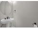 Stylish powder room featuring a pedestal sink with black hardware at 10249 Spring Lake Dr, Clermont, FL 34711