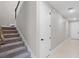 Carpeted stairs with a wooden banister lead to the upper level of the home at 10249 Spring Lake Dr, Clermont, FL 34711