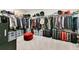 Spacious walk-in closet with ample shelving, hanging space, and storage containers for optimal organization at 10249 Spring Lake Dr, Clermont, FL 34711