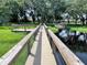 Community scenic walkway with railings along the lake, leading to a dock and boat launch at 10249 Spring Lake Dr, Clermont, FL 34711
