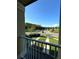 Balcony view featuring lush green landscaping and a bright blue sky in the background at 10506 Green Ivy Lane, Orlando, FL 32832