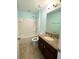 Bathroom with shower-tub combo, dark wood vanity and beige granite countertops at 10506 Green Ivy Lane, Orlando, FL 32832