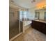 Elegant bathroom features double sinks, granite countertops, a soaking tub, and a glass-enclosed shower at 10506 Green Ivy Lane, Orlando, FL 32832