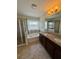 Elegant bathroom features double sinks, granite countertops, a soaking tub, and a glass-enclosed shower at 10506 Green Ivy Lane, Orlando, FL 32832
