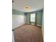 Bedroom with bright blue walls, carpet flooring, and natural light at 10506 Green Ivy Lane, Orlando, FL 32832