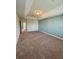 Spacious carpeted bedroom featuring a decorative tray ceiling and fresh, neutral paint at 10506 Green Ivy Lane, Orlando, FL 32832