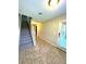 Welcoming hallway with tile flooring, staircase, and natural light streaming in from the entrance, adjacent to several rooms at 10506 Green Ivy Lane, Orlando, FL 32832