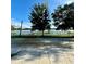 Scenic lake view with mature trees and a white fence creating a peaceful backdrop at 10506 Green Ivy Lane, Orlando, FL 32832
