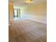 Expansive living room with neutral carpeting, wainscoting, and natural light creating an inviting atmosphere at 10506 Green Ivy Lane, Orlando, FL 32832