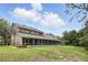 Expansive backyard with large screened-in patio, lush green grass, and mature trees at 10664 Spring Buck Trl, Orlando, FL 32825