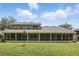 Expansive screened-in lanai overlooking the home's lush green backyard at 10664 Spring Buck Trl, Orlando, FL 32825