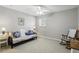 Bright bedroom features a futon, neutral walls, ceiling fan, and a rocking chair at 10664 Spring Buck Trl, Orlando, FL 32825