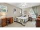Cozy bedroom featuring a decorative quilt, wooden furniture, and plenty of natural light at 10664 Spring Buck Trl, Orlando, FL 32825