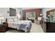 Well-lit bedroom with a decorative quilt, stylish furnishings, and a relaxing sitting area at 10664 Spring Buck Trl, Orlando, FL 32825