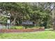 Image of the Deer Lakes community entrance sign framed by mature trees and greenery at 10664 Spring Buck Trl, Orlando, FL 32825