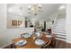 Traditional dining room featuring hardwood floors, chandelier, stairs and seating for six at 10664 Spring Buck Trl, Orlando, FL 32825