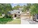 Charming home featuring a two-car garage, brick accents, manicured lawn, and beautiful landscaping at 10664 Spring Buck Trl, Orlando, FL 32825