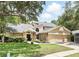 Charming two-story home with a well-maintained lawn, mature trees and a two car garage at 10664 Spring Buck Trl, Orlando, FL 32825