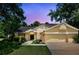 Charming two-story home with a well-maintained lawn, mature trees and a two car garage at 10664 Spring Buck Trl, Orlando, FL 32825