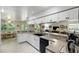 Bright kitchen featuring white cabinetry, a breakfast bar, and seamless transition to the living area at 10664 Spring Buck Trl, Orlando, FL 32825