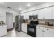 Well-equipped kitchen with stainless steel appliances, white cabinetry, and plenty of counter space at 10664 Spring Buck Trl, Orlando, FL 32825