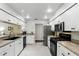 Bright and functional kitchen featuring stainless steel appliances, and white cabinetry at 10664 Spring Buck Trl, Orlando, FL 32825