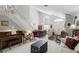 Bright and airy living room with a piano, staircase, and hardwood floors at 10664 Spring Buck Trl, Orlando, FL 32825