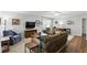 Bright living room with large windows, comfortable seating, and an entertainment center for relaxation and enjoyment at 10664 Spring Buck Trl, Orlando, FL 32825