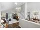 Bright and airy living room featuring tall ceilings, staircase, and hardwood floors at 10664 Spring Buck Trl, Orlando, FL 32825