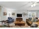 Spacious living room with ceiling fan, large windows, and comfortable seating for relaxing and entertaining at 10664 Spring Buck Trl, Orlando, FL 32825