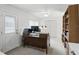 Bright office space with a ceiling fan, built-in bookshelves, closet, and natural light for a productive work environment at 10664 Spring Buck Trl, Orlando, FL 32825