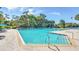 Relaxing community pool surrounded by lush landscaping and lounge chairs, perfect for enjoying sunny days at 10664 Spring Buck Trl, Orlando, FL 32825