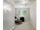 Comfortable sitting room with a window view, accent chair, and neutral decor at 10664 Spring Buck Trl, Orlando, FL 32825