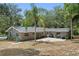 Brick home with brick patio, mature trees, and green yard at 1090 Braddock Rd, Deltona, FL 32725