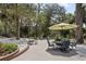 Outdoor patio space with multiple seating areas beneath mature trees at 1090 Braddock Rd, Deltona, FL 32725