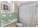 Quaint bathroom featuring a vintage sink, tiled walls, shower with curtain, and storage cabinet at 1090 Braddock Rd, Deltona, FL 32725