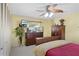 Bright bedroom with wood furnishings, a large dresser, closet, and ceiling fan at 1090 Braddock Rd, Deltona, FL 32725