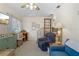 Bonus room with blue recliner, storage cabinet, and view of stairway at 1090 Braddock Rd, Deltona, FL 32725