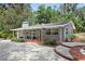 Charming single-story brick home featuring a cozy front porch and well-manicured landscaping at 1090 Braddock Rd, Deltona, FL 32725