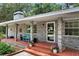Attractive brick home featuring a charming front porch, flower pots, and brick-lined walkway at 1090 Braddock Rd, Deltona, FL 32725